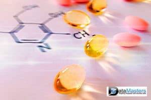 Blue back ground image with image on the right showing pills laying on top of a chemical formula notation.