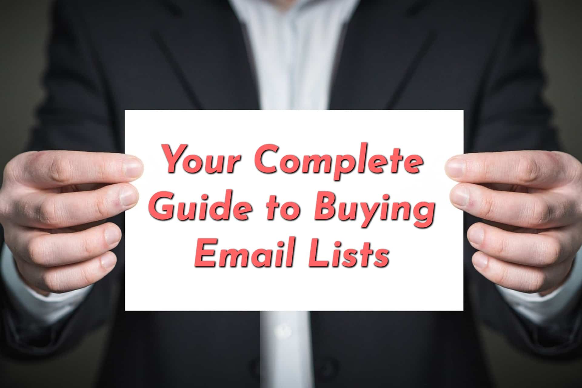 Man holding a sig reading Your Complete Guide to Buying Email Lists