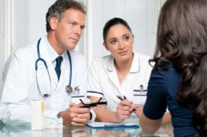 Young female patient discuss with doctors on her medical exam at hospital