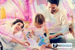 Image of a young couple and a child seated and laying on the floor with multicolor background