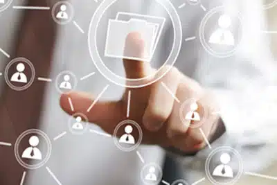 Choosing Mailing Lists A close up of a man touching a file icon on a screen.